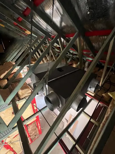 Ducted indoor unit and flexible duct takeoffs installed in the roof frame of a new build.
