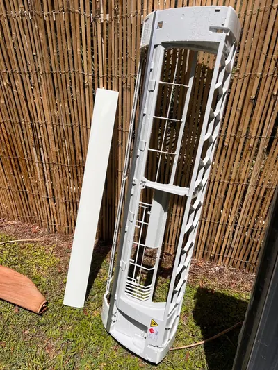 Indoor fan coil unit with the casing removed during a service call.