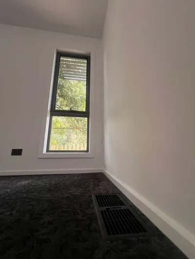 Two floor supply outlets set into the carpet in a bedroom.